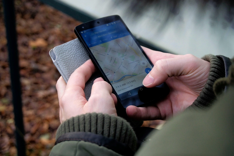 banking-marketing view of a map on a smartphone that someone is holding next to their wallet